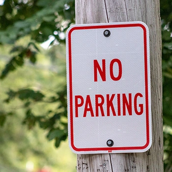 No parking sign on wooden pole